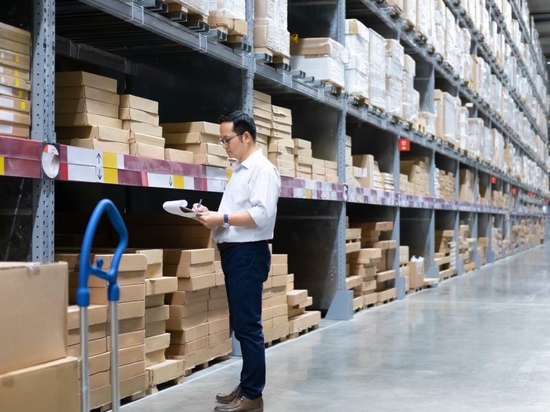 Man warehouse worker checking stock.